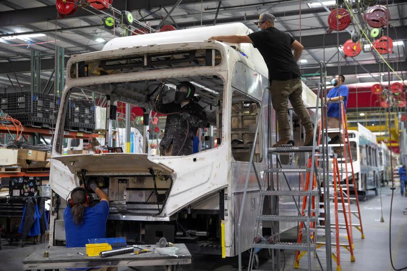 FILE PHOTO: Workers build electric buses at the BYD electric bus factory in Lancaster, California