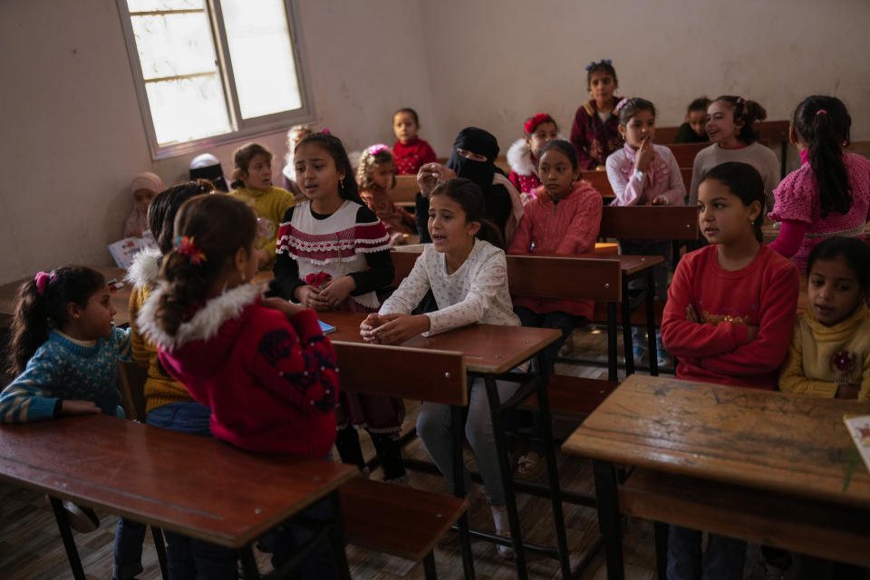 Syrian young girls attend a school class in an orphanage refugee camp for displaced people run by the Turkish Red Crescent in Sarmada district, on the outskirts north of Idlib, Syria, Friday, Nov. 26, 2021. (AP Photo/Francisco Seco)