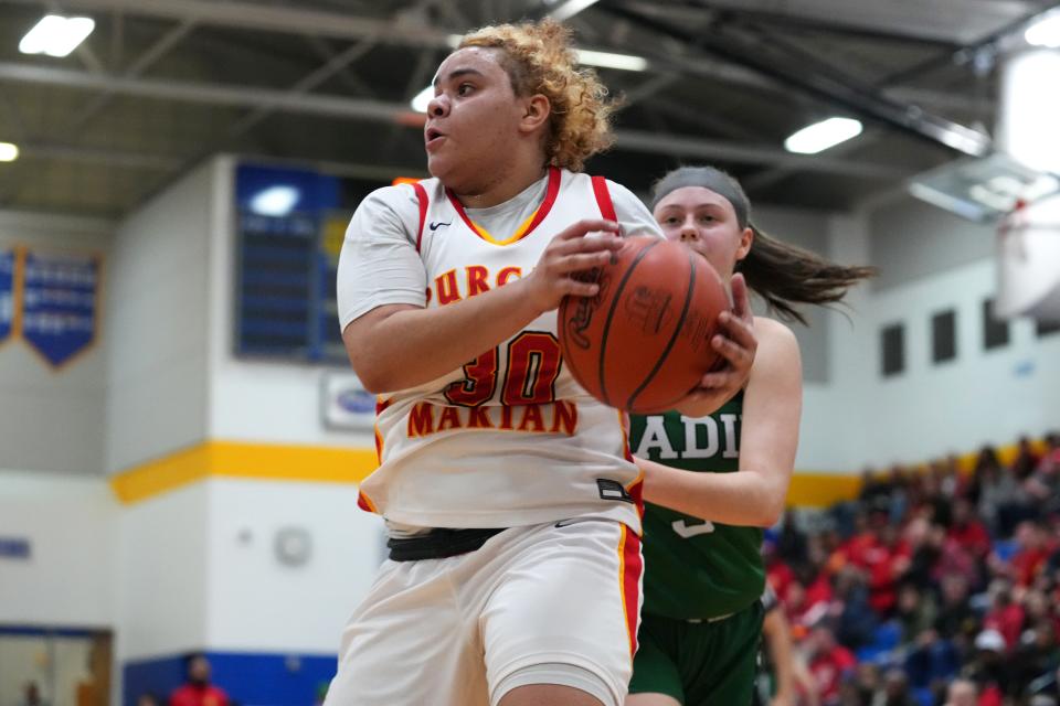 Purcell Marian's Jayda Mosley (30) rebounds the ball in the first half of the Division II girls regional final game against Badin Friday at Springfield High School.