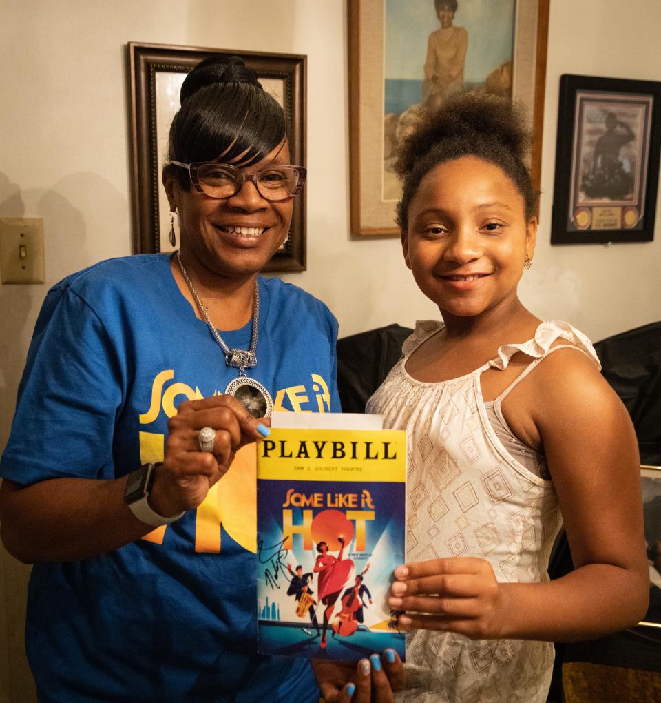 Broadway star NaTasha Yvette Williams' friend Carolyn Armstrong and 10-year-old Carrington Tucker, a member of Williams' extended family, hold an autographed program for the "Some Like It Hot" musical that Williams is performing in. Armstrong and Carrington attended a viewing party for the Tony Awards at the home of Williams' father on Sunday, June 11, 2023, as Williams was nominated for an award.