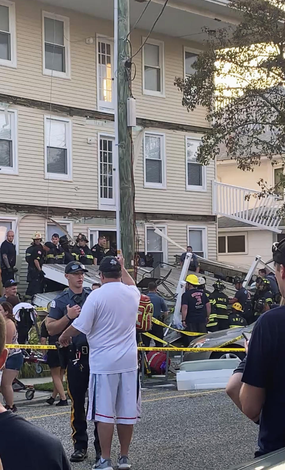 In this photo provided by James Macheda, first responders work the scene of a building structure damage in Wildwood, N.J., Saturday, Sept. 14, 2019. Multiple levels of decking attached to a building collapsed Saturday evening at the Jersey Shore, trapping people and injuring several, including children, officials and witnesses said. (James Macheda via AP)