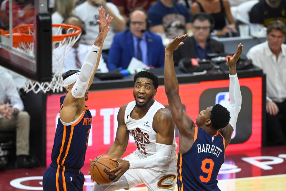 Cleveland Cavaliers guard Donovan Mitchell (45) drives between New York Knicks guard Josh Hart (3) and guard RJ Barrett (9) in the second quarter of Game 1 of the 2023 NBA playoffs at Rocket Mortgage FieldHouse.