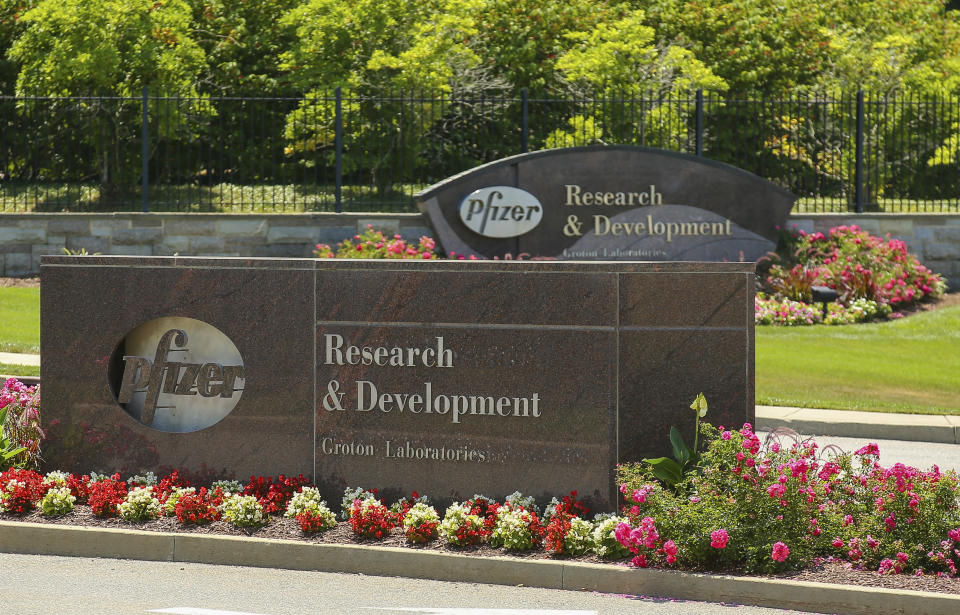 Pfizer signs are seen out front of the Pfizer Research & Development Laboratories Wednesday, July 22, 2020, in Groton, Conn. Pfizer on Tuesday, July 28, reported a 32% plunge in second-quarter profit, as the global coronavirus pandemic limited marketing of and new prescriptions for its medicines. Still, the biggest U.S. drugmaker posted a solid profit and nudged up parts of its 2020 financial forecast. (AP Photo/Stew Milne)