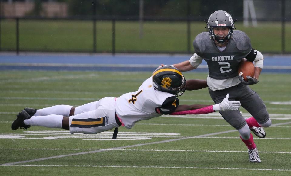 McQuaid's Allen Nesmith makes a diving tackle on Brighton quarterback Tyler Martinovich.