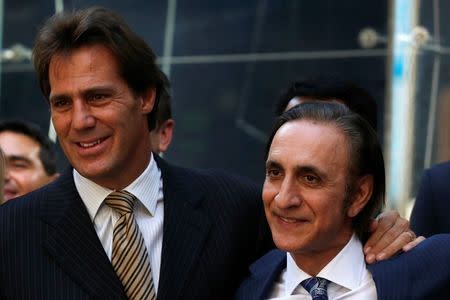 FireEye Inc. Chairman and CEO David DeWalt (L) and Founder Ashar Aziz pose together outside the Nasdaq Market site in Times Square following the company's debut on the Nasdaq exchange in New York, September 20, 2013. REUTERS/Brendan McDermid