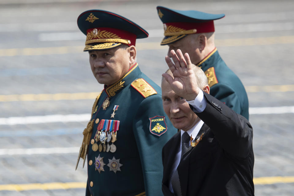 Russian President Vladimir Putin, center, and, Defense Minister Sergei Shoigu, left, leave Red Square after the Victory Day military parade marking the 75th anniversary of the Nazi defeat in Moscow, Russia, Wednesday, June 24, 2020. Russian President Vladimir Putin hailed the defeat of Nazi Germany at the traditional massive Red Square military parade, which was delayed by more than a month because of the invisible enemy of the coronavirus. The parade is usually held May 9 on Victory Day, Russia's most important secular holiday but was postponed until Wednesday due to the pandemic. (AP Photo/Pavel Golovkin, Pool)