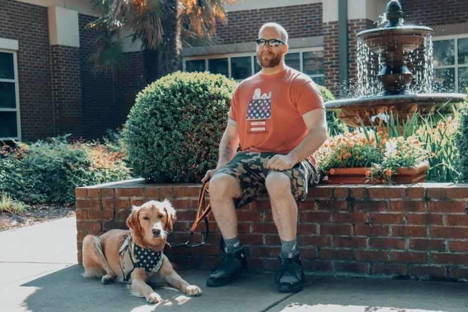 A veteran poses with his Battle Buddy at Clemson University.