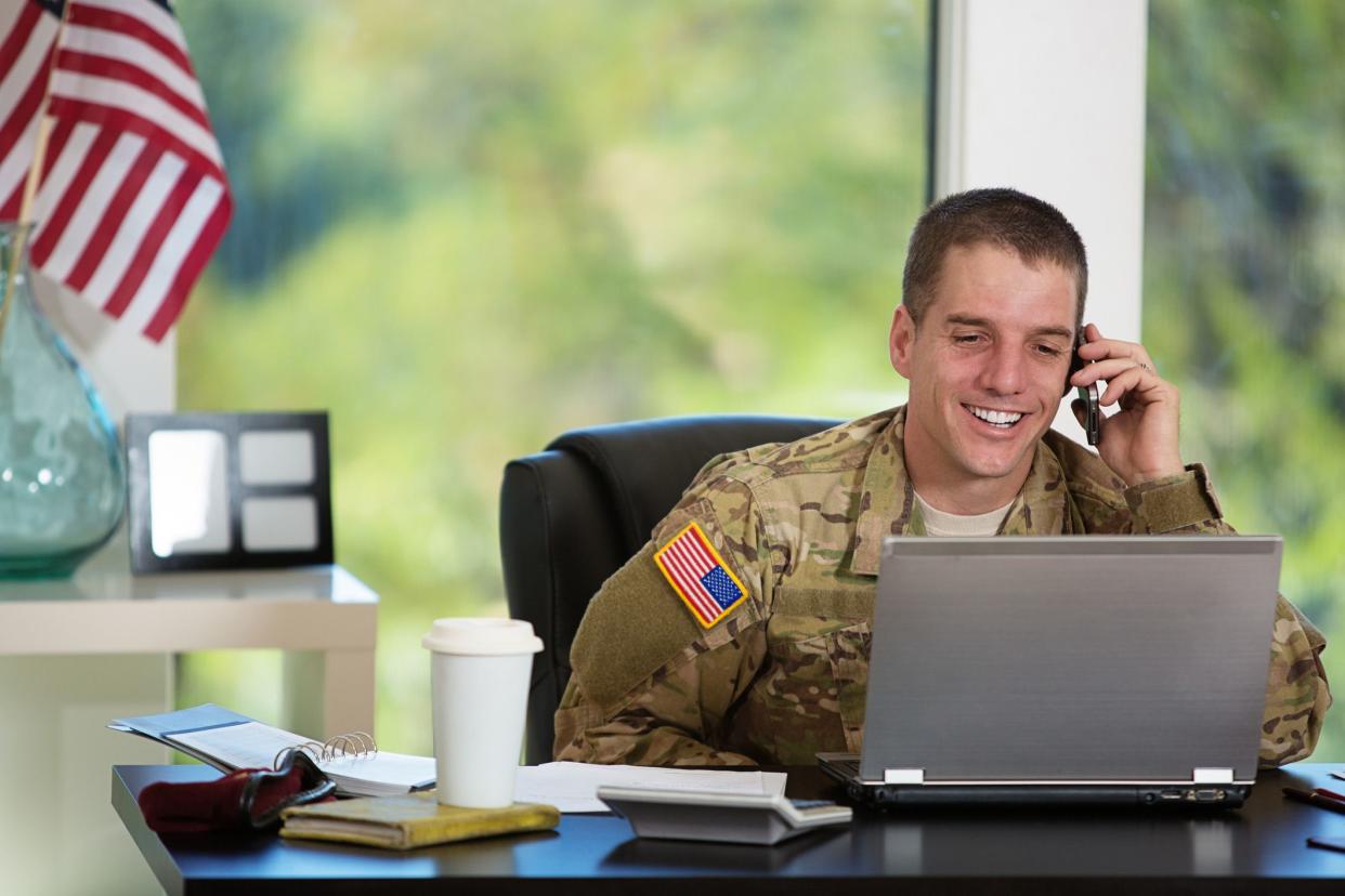 smiling soldier on phone in office