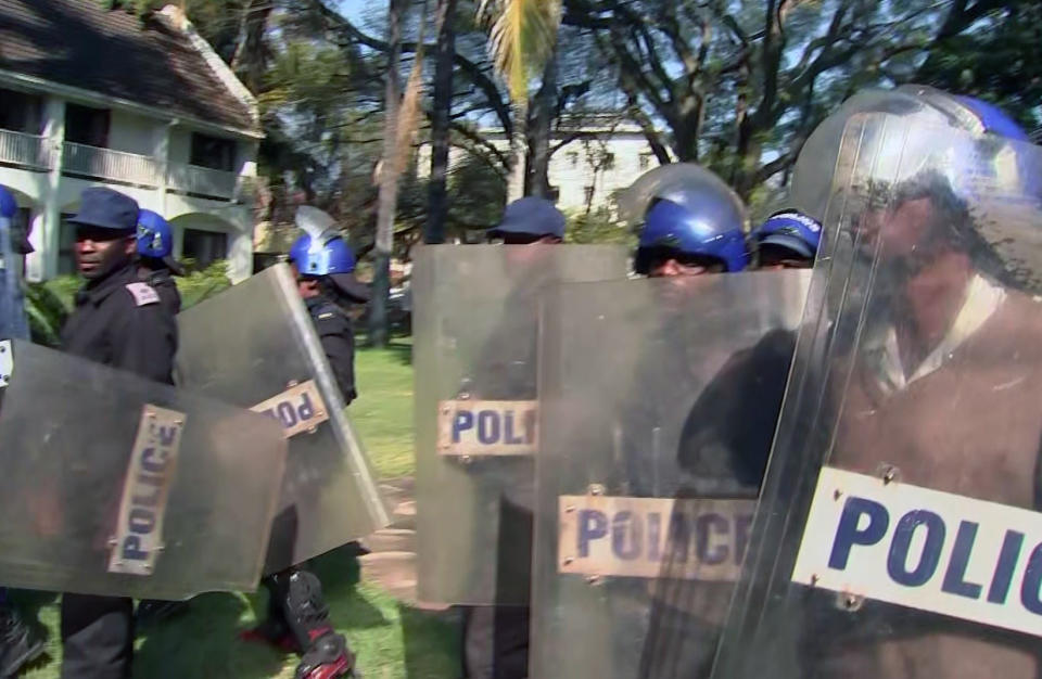 In this image made from video, police arrive at a press conference by opposition leader Chamisa in Harare, Friday, Aug. 3, 2018. Zimbabwean police have broken up a press conference by opposition leader Chamisa, who rejects election results. (AP Photo)