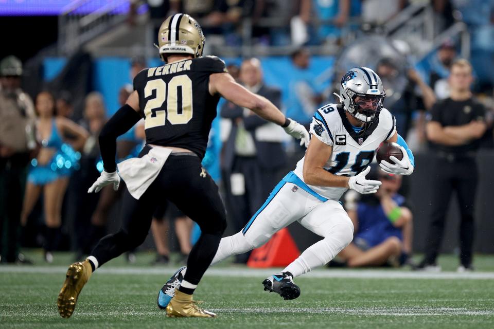 CHARLOTTE, NORTH CAROLINA - SEPTEMBER 18: Adam Thielen #19 of the Carolina Panthers runs with the ball after a catch against Pete Werner #20 of the New Orleans Saints during the first quarter in the game at Bank of America Stadium on September 18, 2023 in Charlotte, North Carolina. (Photo by Jared C. Tilton/Getty Images)
