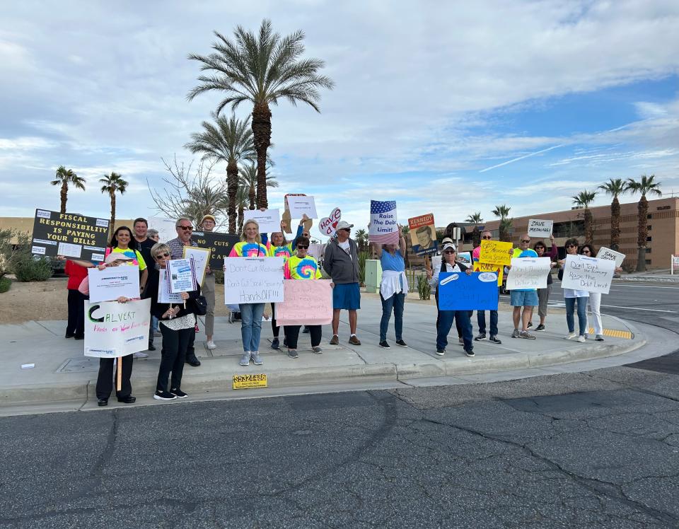 Demonstrators with a new citizens' group gathered near Rep. Ken Calvert's office during its grand opening Monday, holding signs that called for protecting Social Security and Medicare programs.