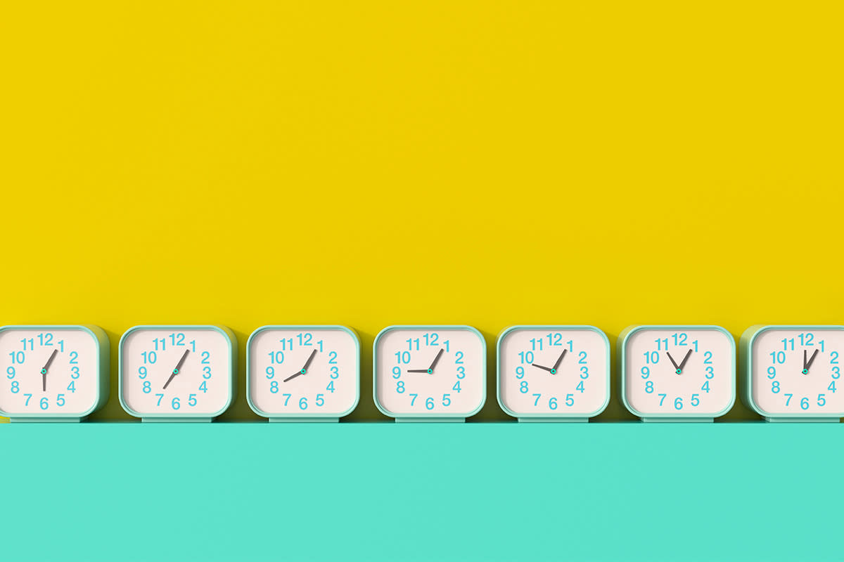 A series of seven clocks with different times lined up against a yellow and teal background