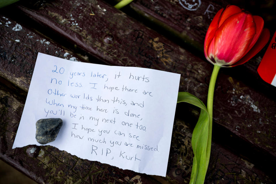 Fans of Nirvana's lead singer, Kurt Cobain, paid homage to the late rock icon with offerings of flowers, unopened beers and handwritten notes on a bench near the home where Cobain died on the 20th anniversary of his death Saturday, April 5, 2014, at Viretta Park in Seattle, Wash. On April 10, Nirvana will be inducted into the Rock and Roll Hall of Fame. (AP Photo/seattlepi.com, Jordan Stead)
