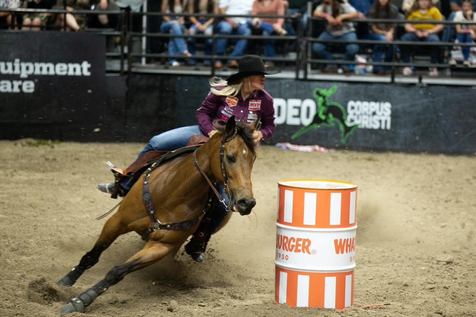 Cassidy Dean, of Wills Point, Texas, bears left around a barrel during barrel racing at Rodeo Corpus Christi at American Bank Center on Wednesday, May 10, 2023.