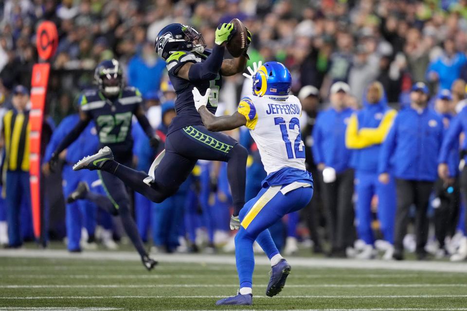 Seattle Seahawks safety Quandre Diggs (6) intercepts a pass intended for Los Angeles Rams wide receiver Van Jefferson (12) during the overtime of an NFL football game Sunday, Jan. 8, 2023, in Seattle. (AP Photo/Stephen Brashear)