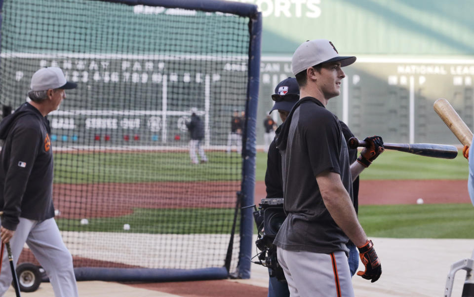 San Francisco Giants right fielder Mike Yastrzemski, right, loosens up during batting practice prior to a baseball game against the Boston Red Sox at Fenway Park in Boston, Tuesday, Sept. 17, 2019. Yastrzemski is the grandson of Red Sox great and Hall of Famer Carl Yastrzemski. (AP Photo/Charles Krupa)