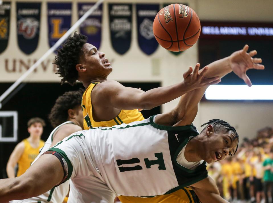 St. X's Jeremiah Jackson battles Trinity's Jayden Johnson for a rebound. The Rocks beat the rival Tigers 50-41 Friday night at Knights Hall on Belleramine University campus. Jan. 6, 2023