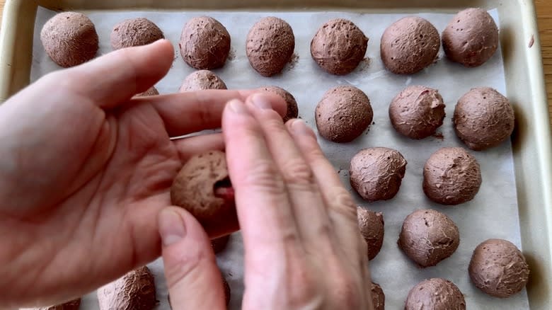 Rolling chilled chocolate cheesecake truffles