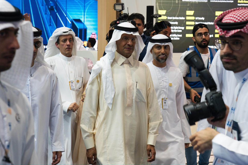 Saudi Arabia's new Energy Minister Prince Abdulaziz bin Salman, center, and United Arab Emirates Energy Minister Suhail al-Mazrouei, right, walk through an energy exhibition in Abu Dhabi, United Arab Emirates, Monday, Sept. 9, 2019. Prince Abdulaziz, as well as the CEOs of Total SA and ENI SpA, were in Abu Dhabi on Monday at the World Energy Congress. (AP Photo/Jon Gambrell)