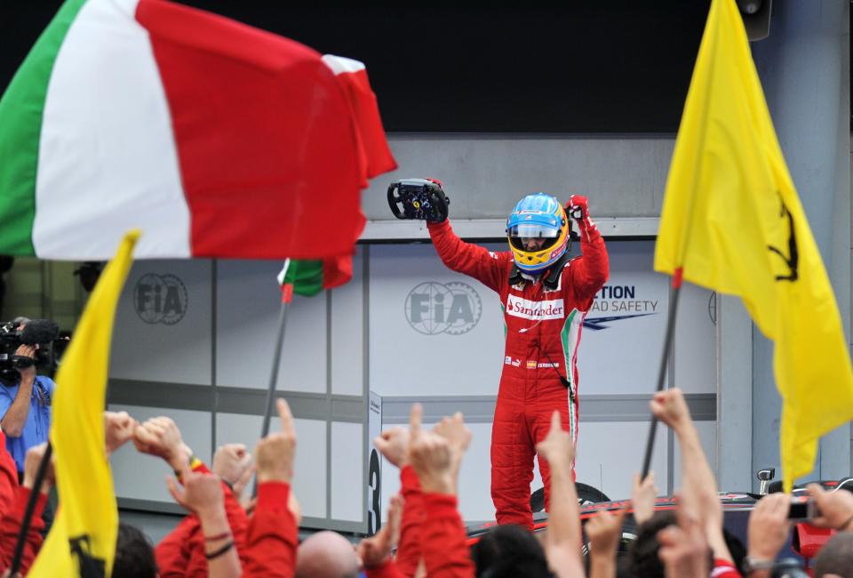 Ferrari driver Fernando Alonso of Spain celebrates after winning Formula One's Malaysian Grand Prix at the Sepang International Circuit in Sepang on March 25, 2012. TOPSHOTS  AFP PHOTO / ROSLAN RAHMAN (Photo credit should read ROSLAN RAHMAN/AFP/Getty Images)
