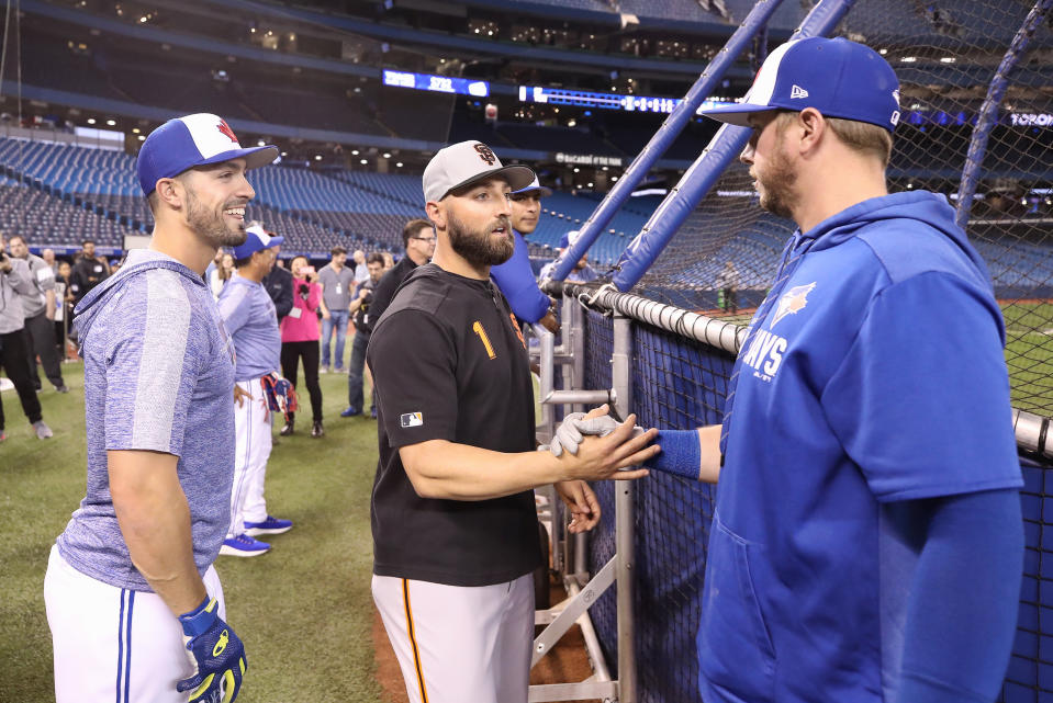 TORONTO, ON - APRIL 23: Kevin Pillar #1 of the San Francisco Giants meets with former teammates Justin Smoak #14 (R) and Randal Grichuk #15 (L) of the Toronto Blue Jays before the start of an MLB game Rogers Centre on April 23, 2019 in Toronto, Canada. (Photo by Tom Szczerbowski/Getty Images)