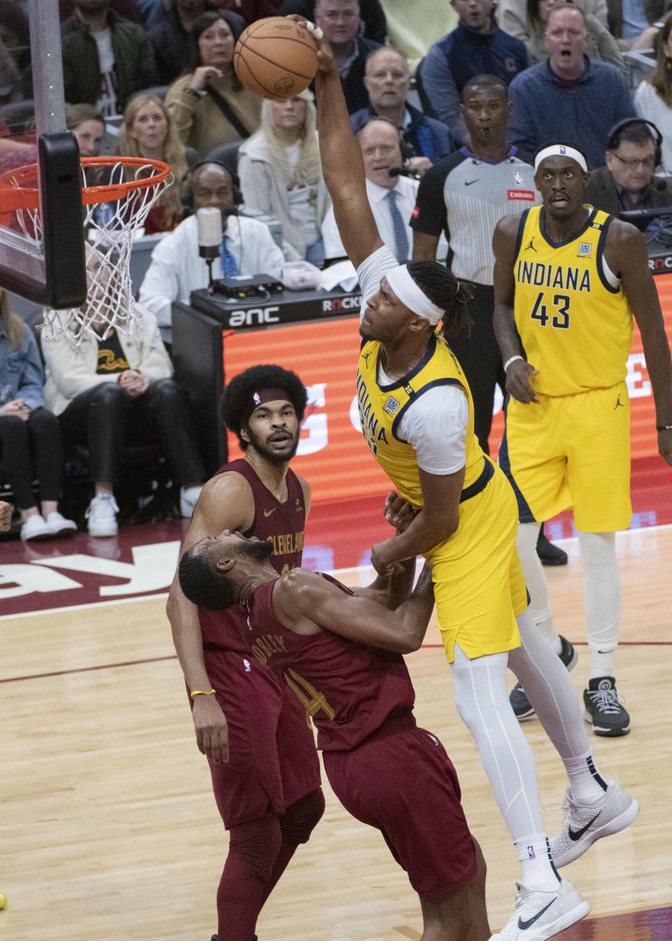 Indiana Pacers' Myles Turner, front right, attempts a dunk over Cleveland Cavaliers' Evan Mobley (4) as Cavaliers' Jarrett Allen, left, and Pacers' Pascal Siakam (43) watch during the first half of an NBA basketball game in Cleveland, Friday, April 12, 2024. (AP Photo/Phil Long)