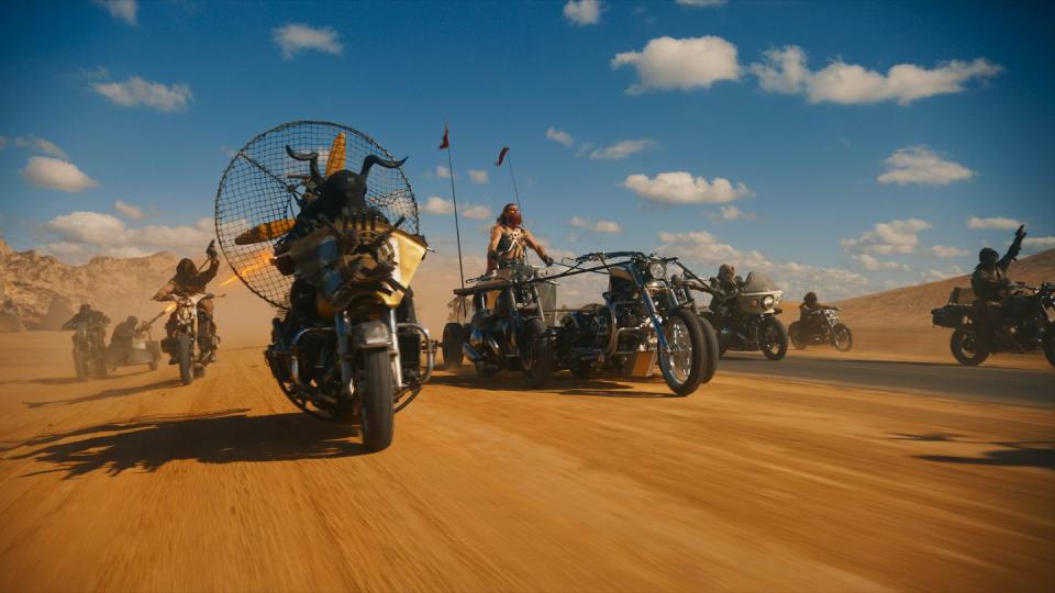 a group of motorcycles on a desert road