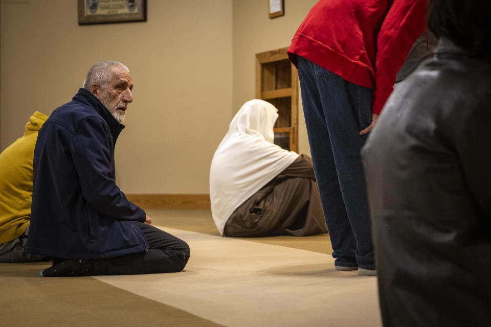 Dr. Mohammad Saber Bahrami participates in prayers at the Islamic Center of Muncie, Ind., on Friday, March 3, 2023. His wife, Bibi Bahrami, is a subject of the documentary "Stranger at the Gate" that tells the story of the relationship she and others in their small Islamic community fostered with a former U.S. Marine who had planned to bomb their community center. (AP Photo/Doug McSchooler)