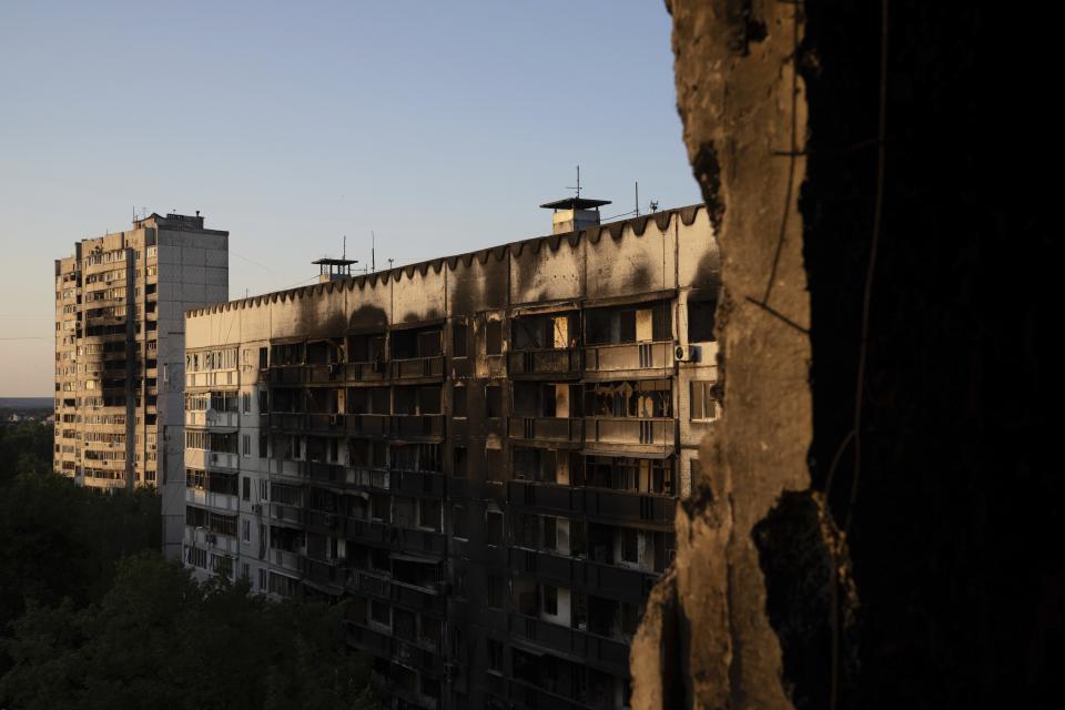 FILE - An apartment building damaged by an attack in Kharkiv, Ukraine, July 4, 2022. As Russia's invasion of Ukraine grinds into its fifth month, some residents close to the front lines remain in shattered and nearly abandoned neighborhoods. One such place is Kharkiv's neighborhood of Saltivka, once home to about half a million people. Only perhaps dozens live there now, in apartment blocks with no running water and little electricity. (AP Photo/Evgeniy Maloletka, File)