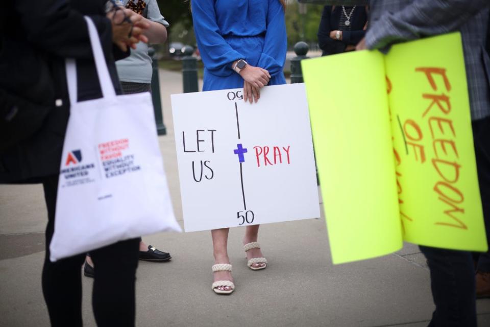 Demonstrators supporting former high school football coach Joseph Kennedy gather outside the US Supreme Court on 25 April (Getty Images)