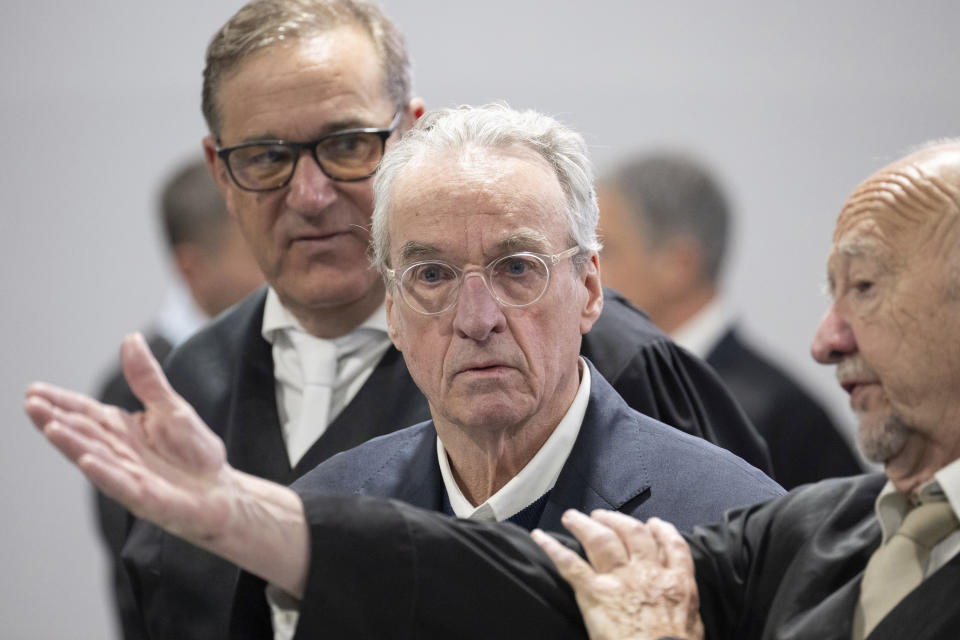 Main defendant Heinrich XIII Prince Reuss, center, is seen at the start of a trial against the alleged leaders of a suspected German far-right coup plot, in the Sossenheim branch of the Frankfurt Higher Regional Court, in Frankfurt, Germany, Tuesday, May 21, 2024. The alleged leaders of a suspected far-right plot to topple the German government went on trial on Tuesday, opening the most prominent proceedings in a case that shocked the country in late 2022. Nine defendants faced judges at a special warehouse-like courthouse built on the outskirts of Frankfurt to accommodate the large number of defendants, lawyers and media dealing with the case. (Boris Roessler/Pool Photo via AP)