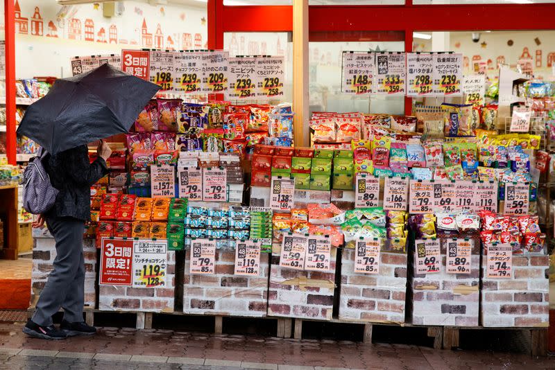 A woman looks at items at a shop in Tokyo