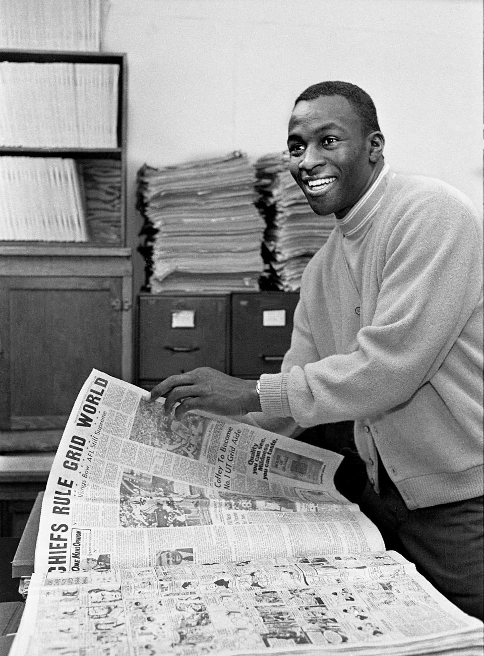 Former Tennessee State star football player Jim Marsalis, who just finished his rookie season as a starter for the Kansas City Chiefs, checks out some newspaper pages of the past Chiefs season in the sports department of The Tennessean on a visit Jan. 28, 1970.