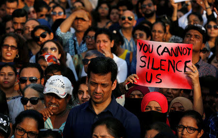 A woman holds a placard as she participates in a protest against the rape of an eight-year-old girl in Kathua near Jammu, and a teenager in Unnao, Uttar Pradesh, in Mumbai, India, April 15, 2018. REUTERS/Danish Siddiqui