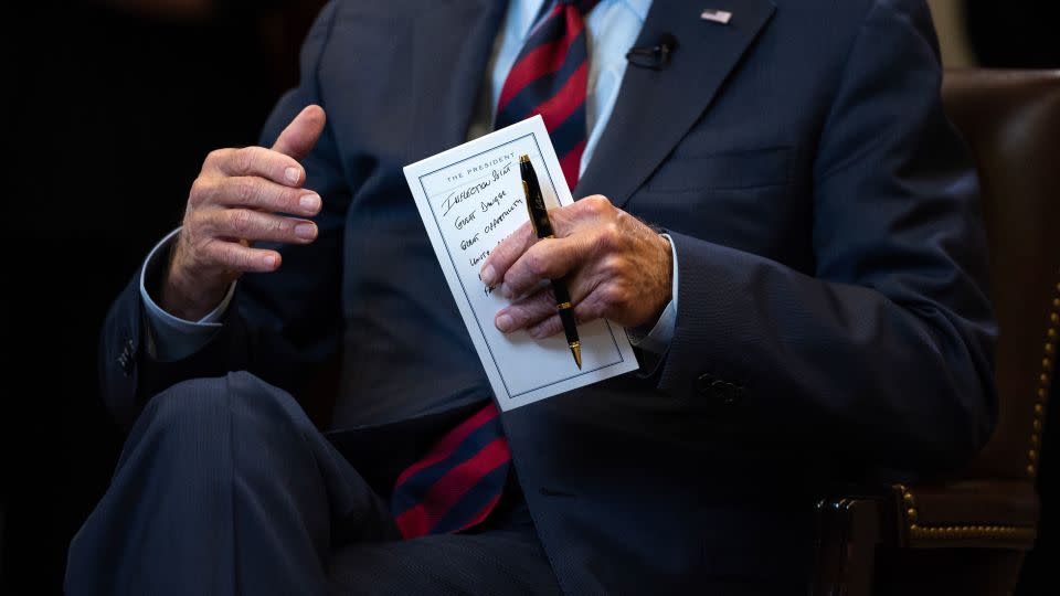 Biden holds his notes as he speaks with Zakaria. - Tom Brenner for CNN