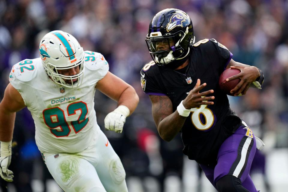 Baltimore Ravens quarterback Lamar Jackson (8) runs against Miami Dolphins defensive tackle Zach Sieler (92) during the second half of an NFL football game in Baltimore, Sunday, Dec. 31, 2023.