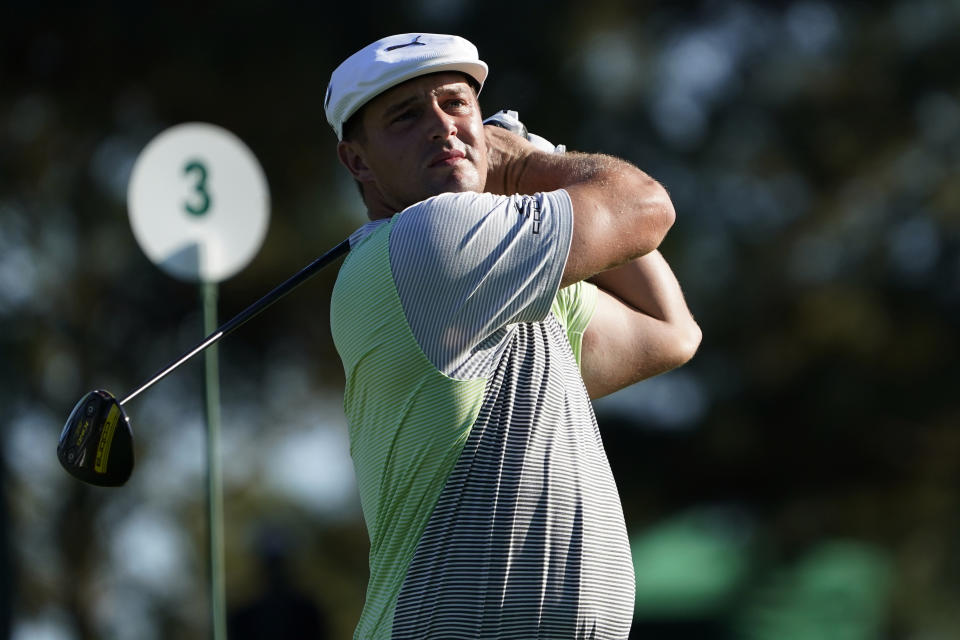 Bryson DeChambeau watches his second tee shot on the third hole after his first ball was lost during the second round of the Masters golf tournament Friday, Nov. 13, 2020, in Augusta, Ga. (AP Photo/David J. Phillip)