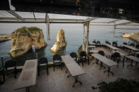 In this Thursday, March 26, 2020 photo, of an empty restaurant and waterpipe place, is seen in Beirut, Lebanon, The new coronavirus causes mild or moderate symptoms for most people, but for some, especially older adults and people with existing health problems, it can cause more severe illness or death. (AP Photo/Hassan Ammar)