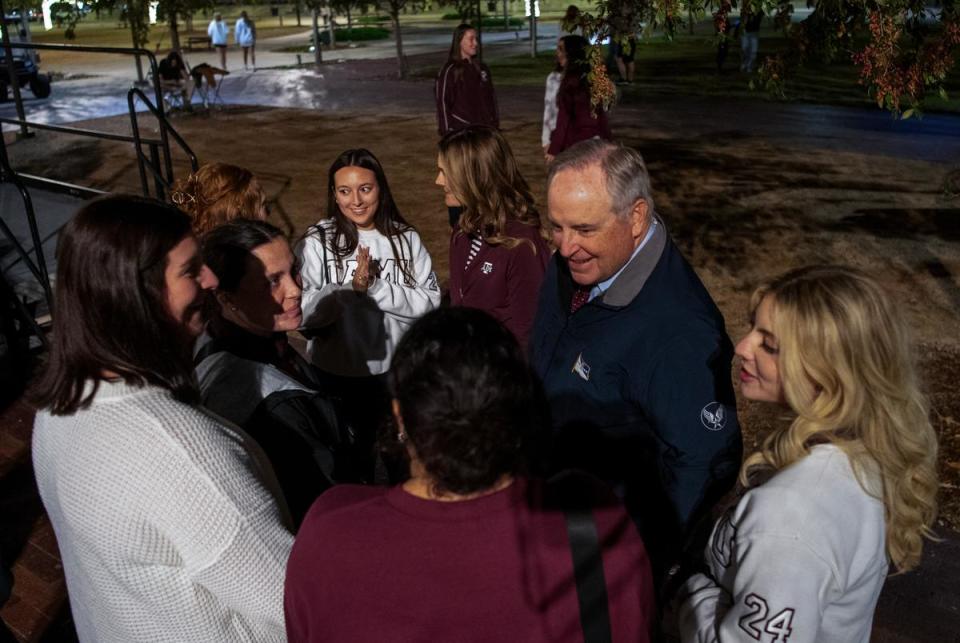 Texas A&M interim president Ret. Gen. Mark A. Welsh III and his wife Betty speak with students during Elephant Walk on Wednesday, Nov. 15 at Aggie Park in College Station.