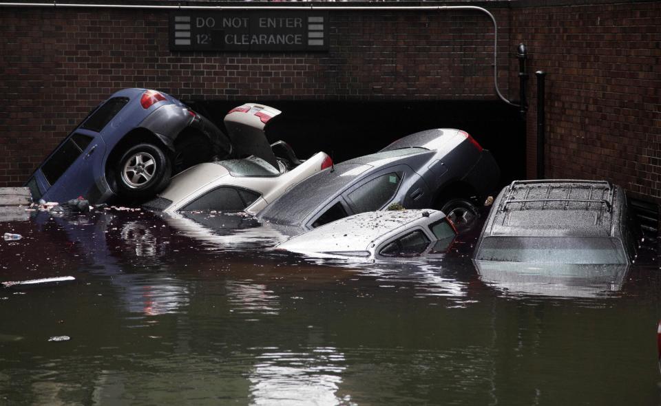 Cars are submerged at the entrance to a parking garage in New York's Financial District in the aftermath of superstorm Sandy, Tuesday, Oct. 30, 2012. New York City awakened Tuesday to a flooded subway system, shuttered financial markets and hundreds of thousands of people without power a day after a wall of seawater and high winds slammed into the city, destroying buildings and flooding tunnels. (AP Photo/Richard Drew)