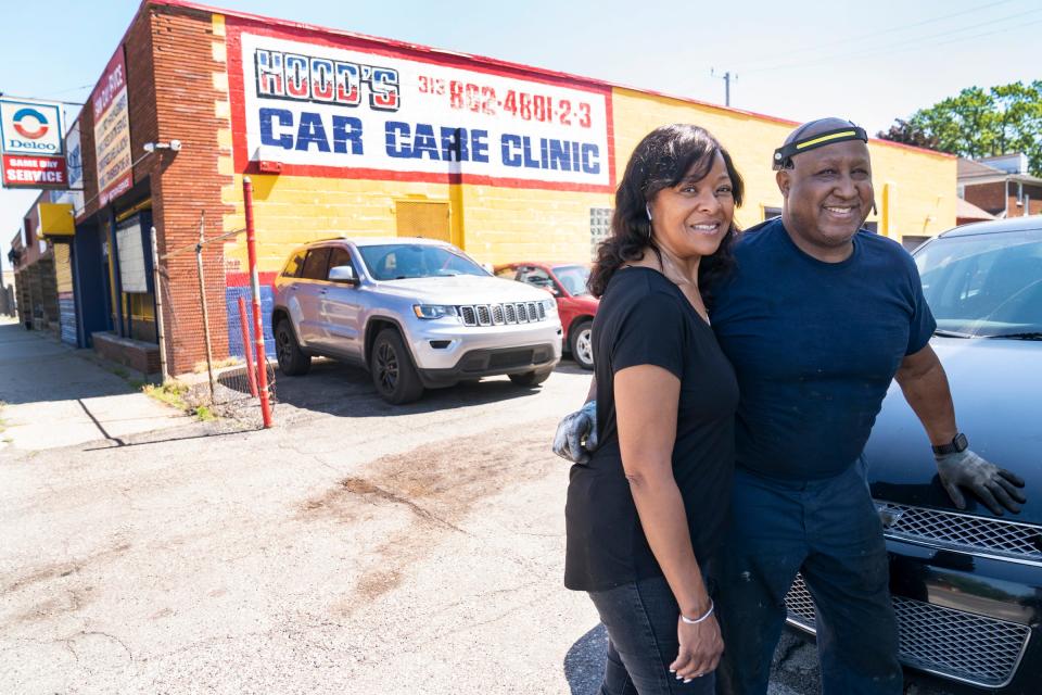 Earl "Butch" Hood Jr., with his wife, Karon Hood, as she manages the office and he works on a Toyota Camry at their shop, Hood's Car Care Clinic in Detroit Friday, June 24, 2022.