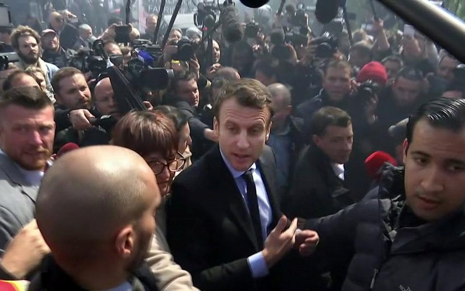 A still image taken from video shows Emmanuel Macron, head of the political movement En Marche !, or Onwards !, and candidate for the 2017 French presidential election, talking to Whirlpool employees in front of the company plant in Amiens - Credit:  REUTERS