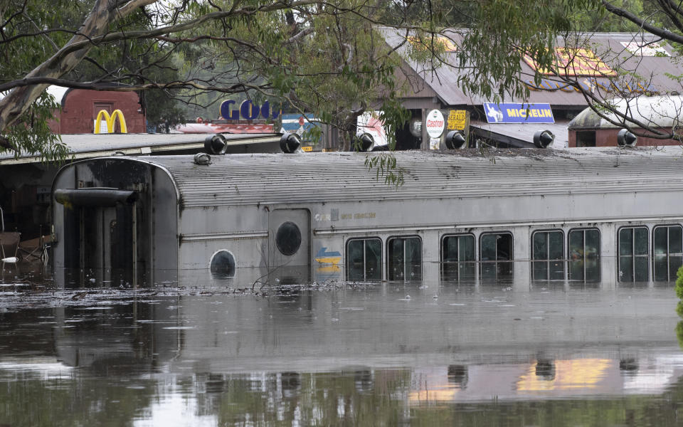 Equipment lies partly submerged at a property in Londonderry on the outskirts of Sydney, Australia, Tuesday, March 23, 2021. Hundreds of people have been rescued from floodwaters that have isolated dozens of towns in Australia's most populous state of New South Wales and forced thousands to evacuate their homes as record rain continues to inundate the countries east coast. (AP Photo/Mark Baker)