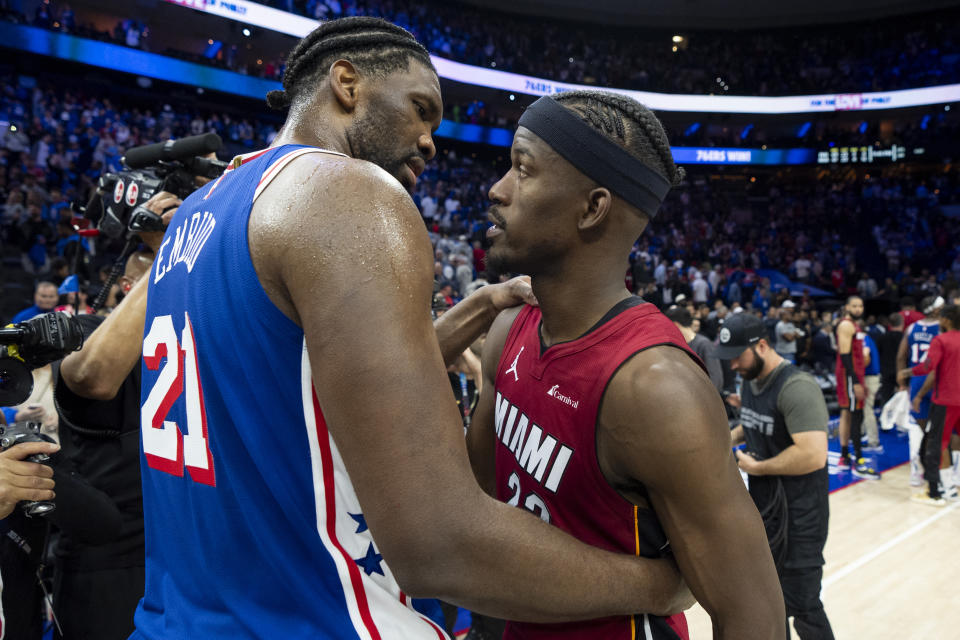 Philadelphia 76ers' Joel Embiid, left, talks with Miami Heat's Jimmy Butler following an NBA basketball play-in tournament game Wednesday, April 17, 2024, in Philadelphia. The 76ers won 105-104. (AP Photo/Chris Szagola)