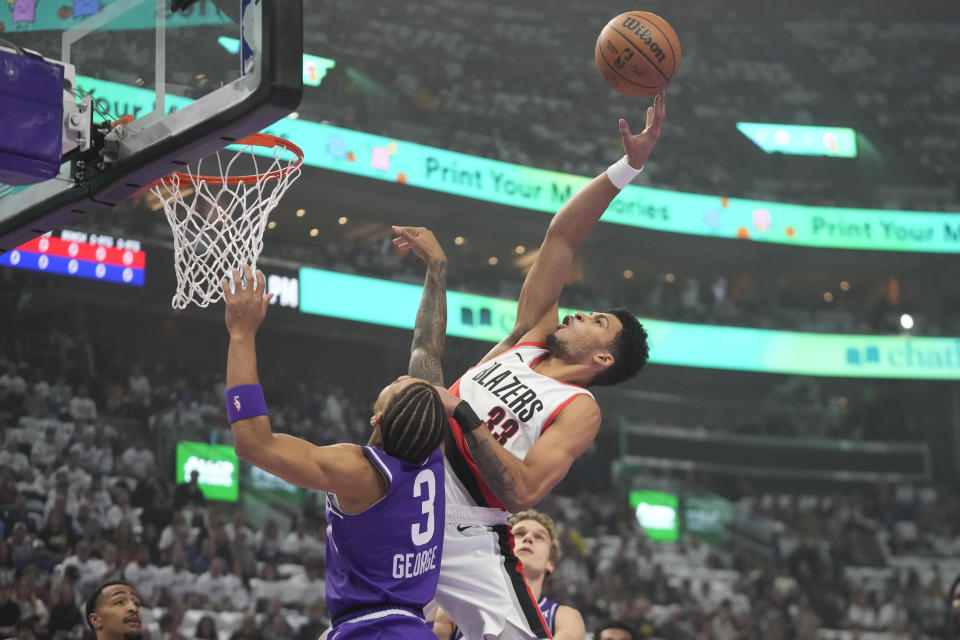 Portland Trail Blazers forward Toumani Camara shoots as Utah Jazz guard Keyonte George (3) defends during the first half of an NBA basketball in-season tournament game, Tuesday, Nov. 14, 2023, in Salt Lake City. (AP Photo/Rick Bowmer)