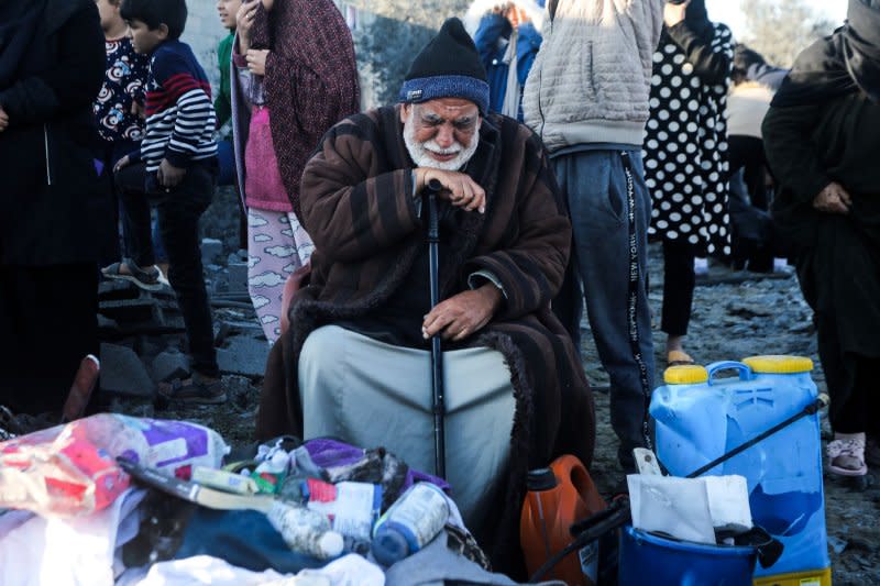 A displaced Palestinian man reacts as he sits among objects salvaged from a house that was used as a shelter by his extended family members, many of whom were reported killed when it was destroyed during an Israeli strike in Morag village, south of Khan Yunis, Gaza Strip, on Sunday. Secretary Antony Blinken kicked off a Middle Eastern diplomatic push as the Israeli-Gaza conflict threatens to expand into a regional one. Photo by Ismael Mohamad/UPI