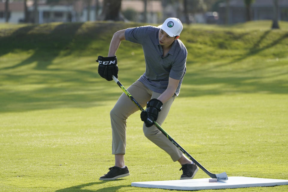 Dallas Star left wing Jason Robertson hits his first shot with a hockey stick during a golf skills competition, Wednesday, Feb. 1, 2023, in Plantation, Fla. The event was part of the NHL All Star weekend. (AP Photo/Marta Lavandier)