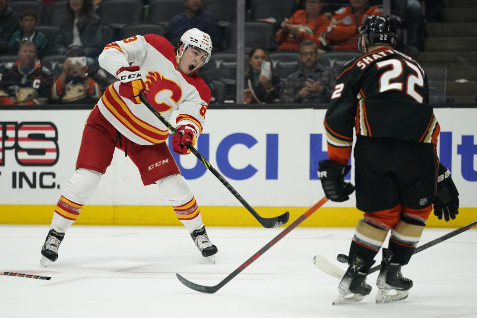 Anaheim Ducks defenseman Kevin Shattenkirk (22) stops a shot by Calgary Flames center Adam Ruzicka (63) during the first period of an NHL hockey game in Anaheim, Calif., Wednesday, April 6, 2022. (AP Photo/Ashley Landis)