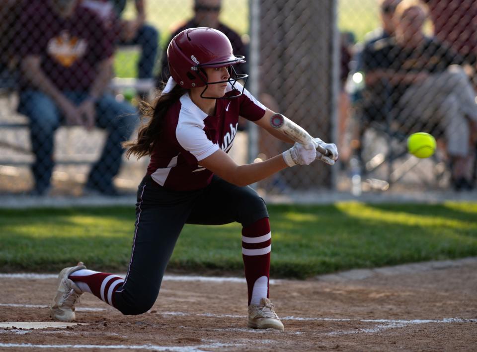 Gibson Southern's Ally Malone (4) drops a bunt against Memorial during their 2023 Class 3A Softball Sectional at Gibson Southern Wednesday evening, May 25, 2023.