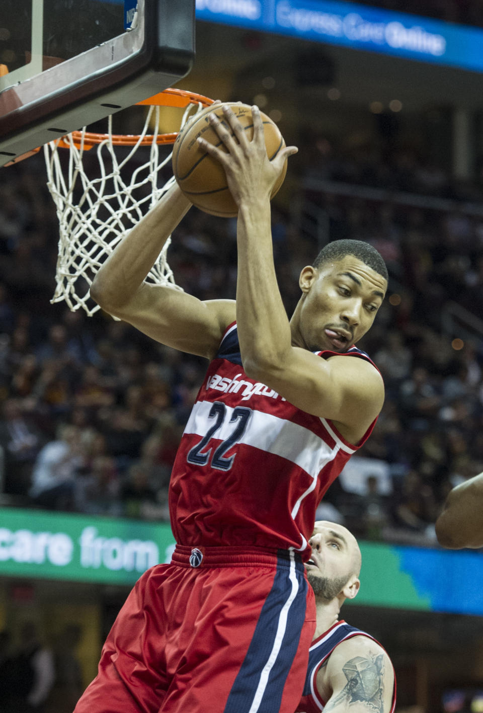 Washington Wizards' Otto Porter Jr., grabs a rebound as teammate Marcin Gortat watches during the first half of an NBA basketball game against the Cleveland Cavaliers in Cleveland, Saturday, March 25, 2017. (AP Photo/Phil Long)